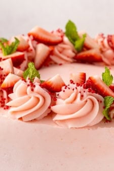 Chopped strawberries garnish a homemade cake.