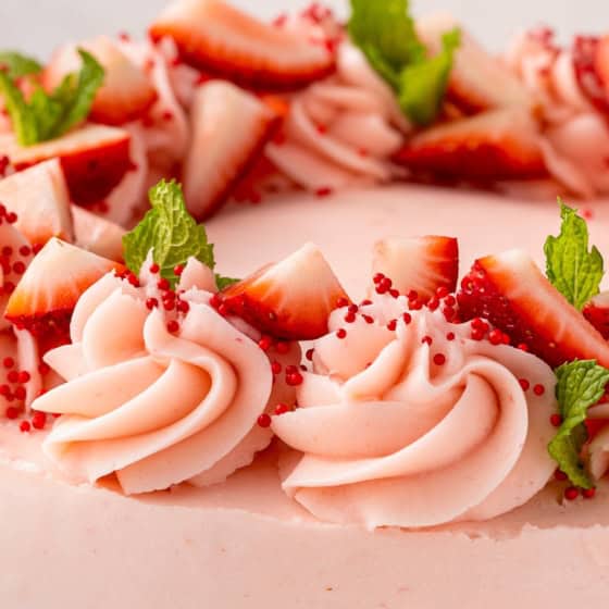 Chopped strawberries garnish a homemade cake.