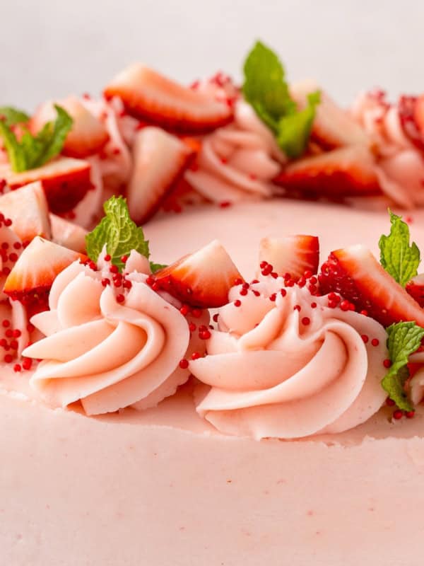 Chopped strawberries garnish a homemade cake.