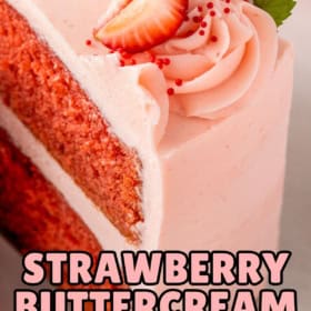 Pink frosting is spread evenly across a strawberry layered cake.