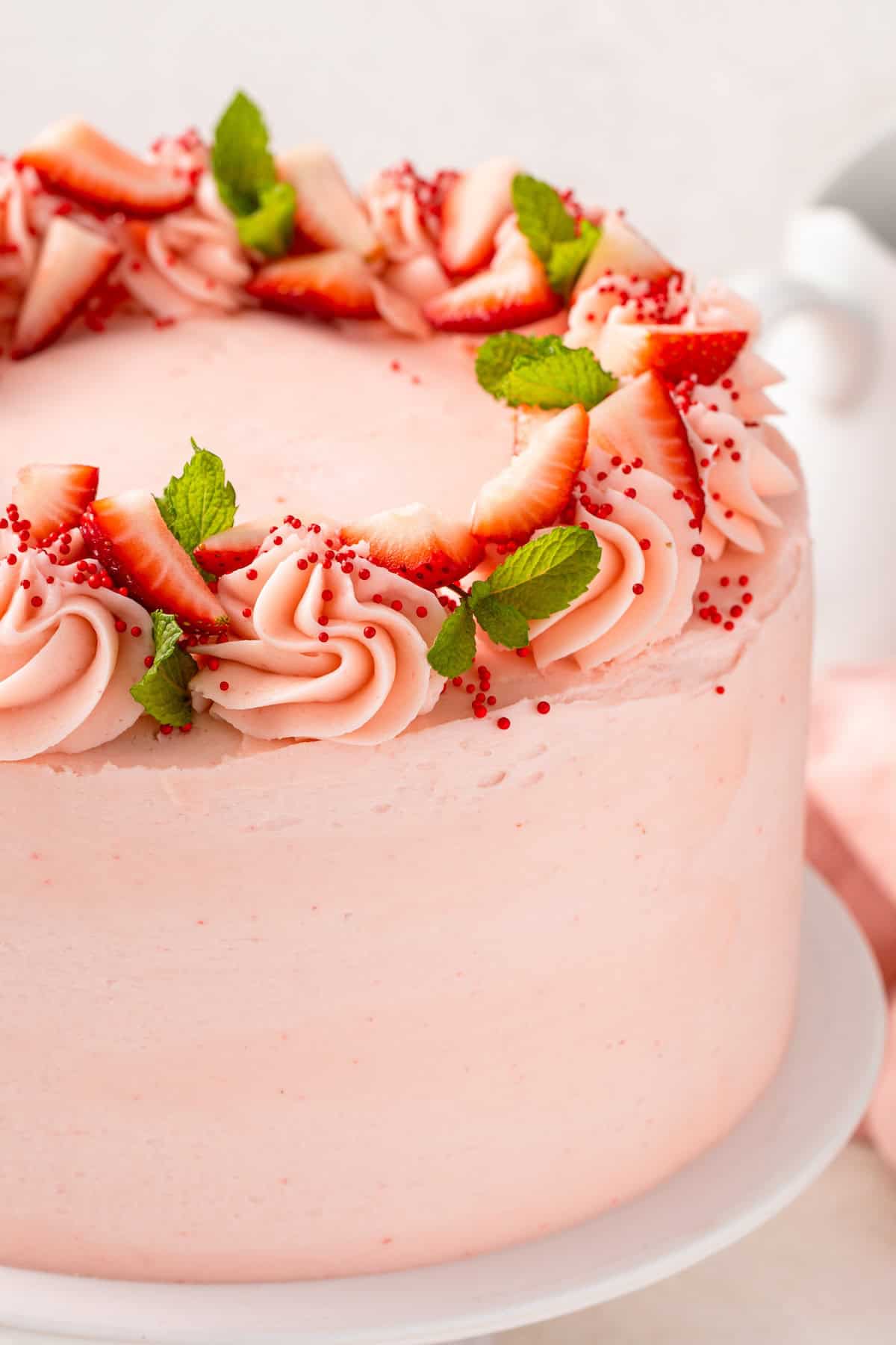 Sweet strawberry frosting is spread all over a stunning cake.