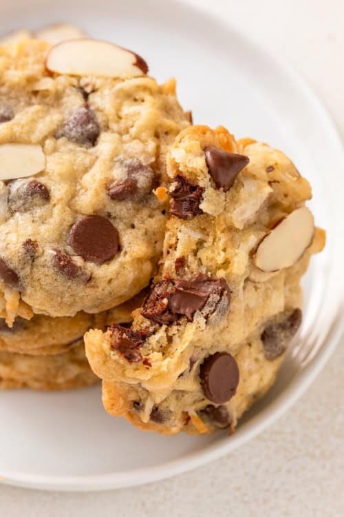 Chewy almond joy cookies are placed on a white plate.