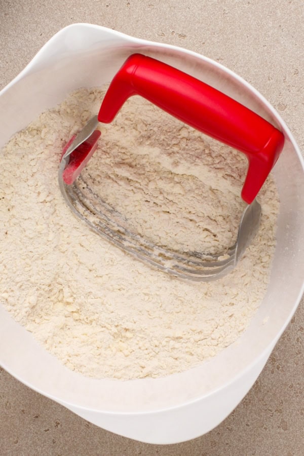 Ingredients are being combined in a large white mixing bowl.