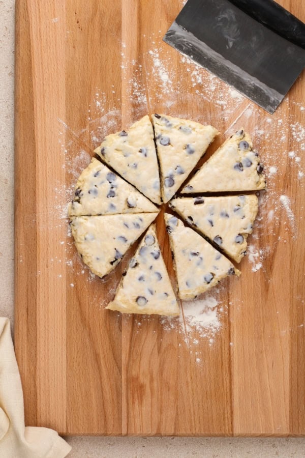 Scone dough has been sliced into eight even triangles.