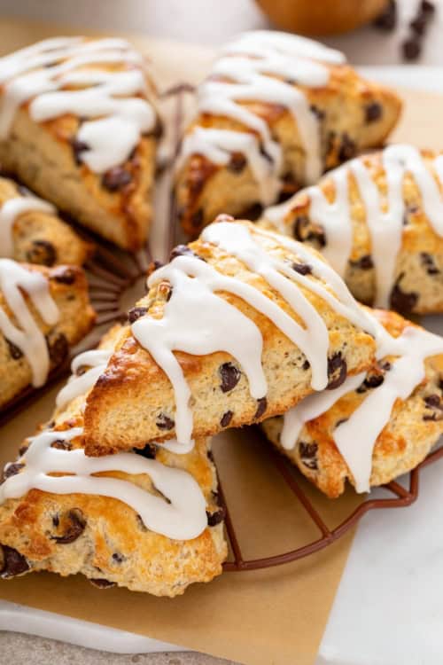 Chocolate chip scones with sweet icing on top are presented in a small circle.