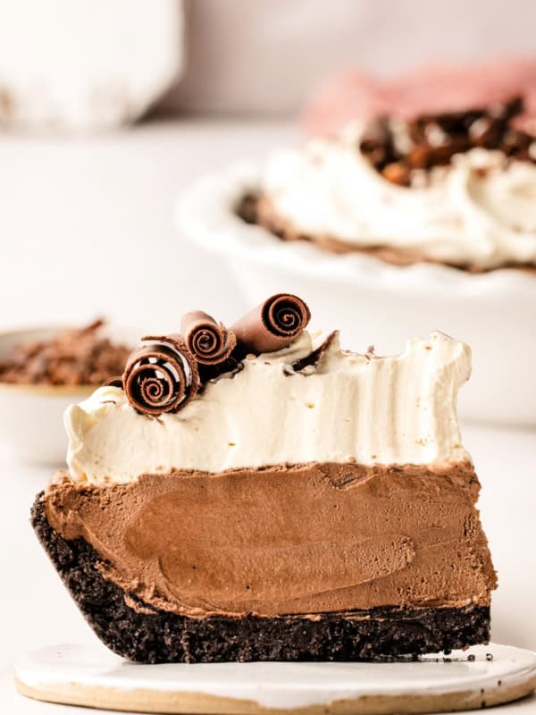 A thick slice of French silk pie is presented on a round plate.