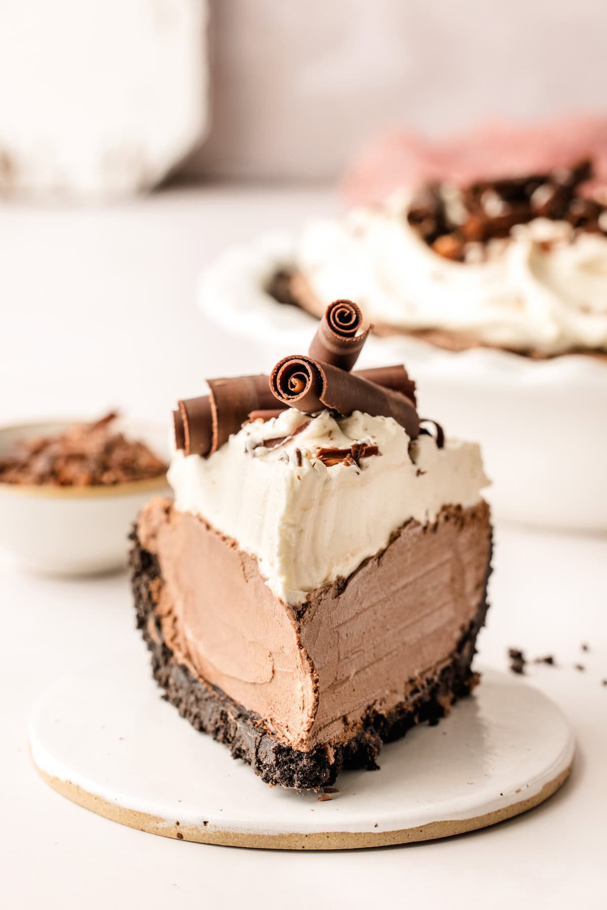 A thick slice of French silk pie is presented on a small white plate.