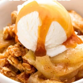 A bowl of homemade easy apple crisp topped with a scoop of vanilla ice cream and drizzled with caramel sauce.