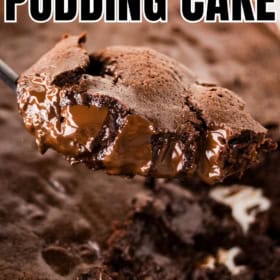 A spoon lifts a serving of rich, gooey chocolate pudding cake from a baking dish, showing a fudgy, melted chocolate center.