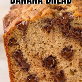 A close-up of a sliced loaf of peanut butter banana bread with melted chocolate chips, showing a moist, dense texture.