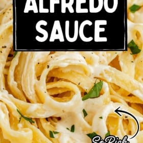 Close-up of creamy fettuccine Alfredo topped with chopped parsley. Overlaid text reads: Easy Homemade Alfredo Sauce. So rich and creamy! thenovicechef.com.