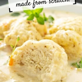 A bowl of creamy chicken and dumplings garnished with herbs. A spoon holds a fluffy dumpling, with visible chicken pieces and carrots in the sauce. Text reads “Chicken & Dumplings made from scratch!”.