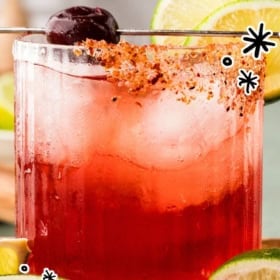 A tart cherry margarita in a glass with a salted rim, garnished with a cherry and lime, surrounded by lime slices. Text reads: Tart Cherry Margarita. Easy Summer Cocktail Recipe. The Novice Chef.